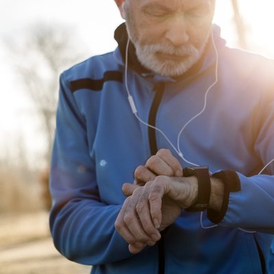 Senior Man using Smart Watch measuring heart rate