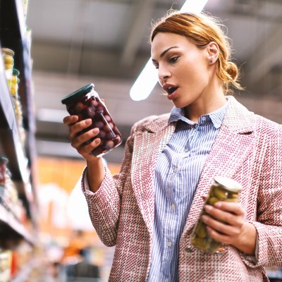 Woman buying food at grocery store.
