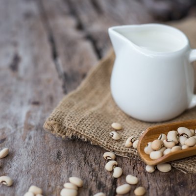Soy milk and soy bean on wooden background