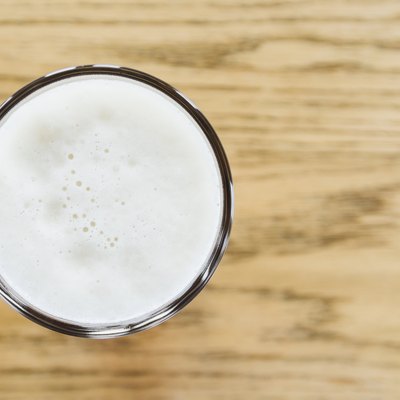 One pint of beer on wooden counter