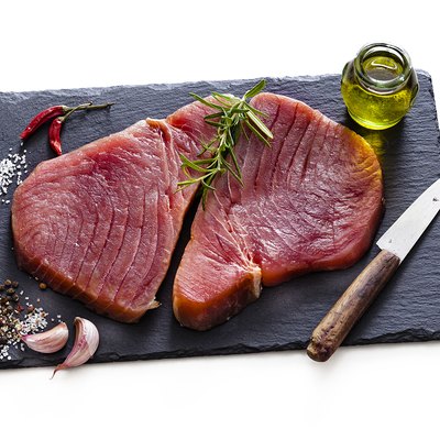 Two raw tuna steaks isolated on white background
