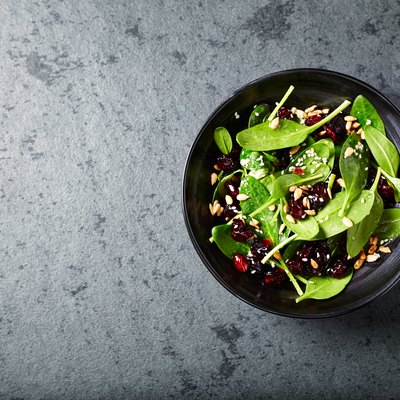 Spinach salad with dried cranberries and pomegranate seeds