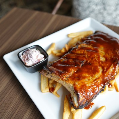 Barbecue pork spare rib - Grilled pork baby ribs with spicy bbq sauce served with coleslaw and french fries.
