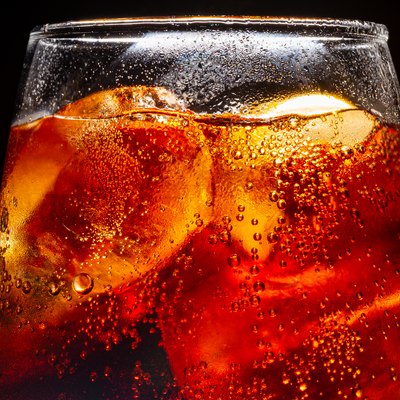 Background of cola with ice and bubbles. Side view background of refreshing cola flavored soda with carbonated with vintage tone