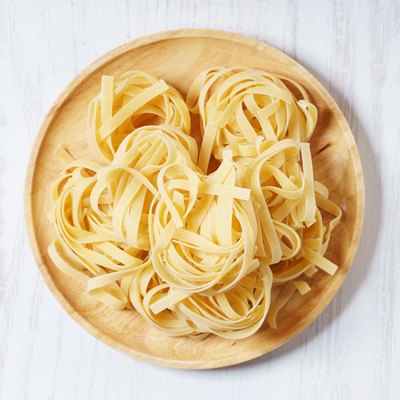 Fresh, uncooked dried pasta on a plate