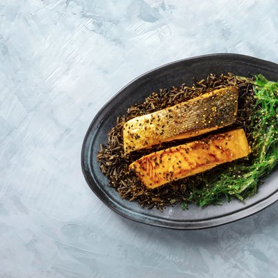 salmon with sesame seeds, wakame and wild black rice, top shot with a place for text