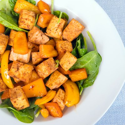 tofu sweet and sour with bell peppers over spinach bed