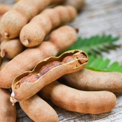 Tamarind and leaves tropical fruit - Sweet tamarind on wooden background