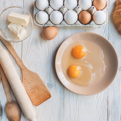Cooking baking ingredients and eggs isolated on table