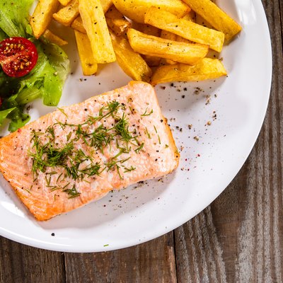 Grilled salmon with French fries and vegetable salad