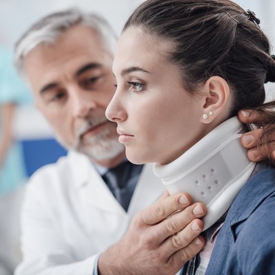 Doctor visiting a patient with cervical collar