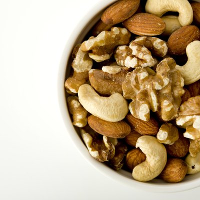 mix of nuts in a cocotte on a white background.