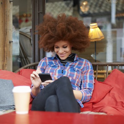 Woman at coffee shop using mobile phone
