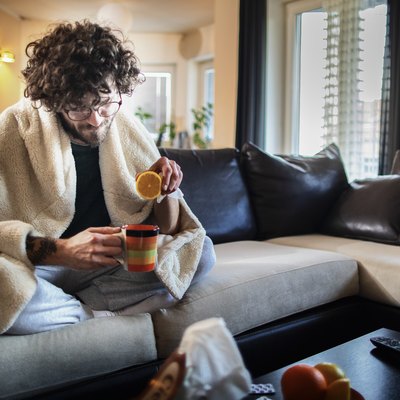 Sick At Home . Man having a cup of tea