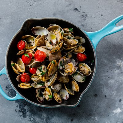 Vongole Seafood Clams with tomatoes and parsley in frying cooking pan