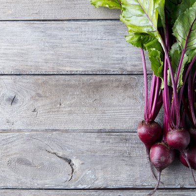 Fresh organic beet, beetroot on grey rustic wooden background. Top view. Copy space.