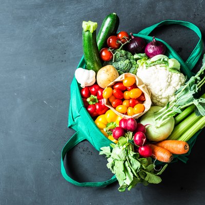 Colorful organic vegetables in green eco shopping bag