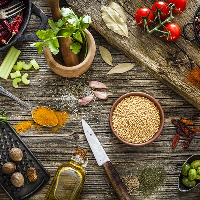 Spices and herbs shot from above on rustic wooden table