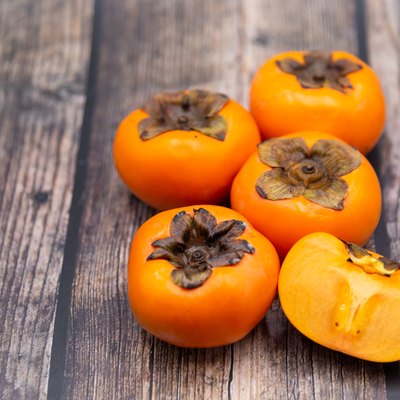 Persimmon fruit on old wooden background, Top view.