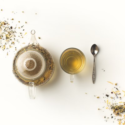 herbal tea in cup and kettle