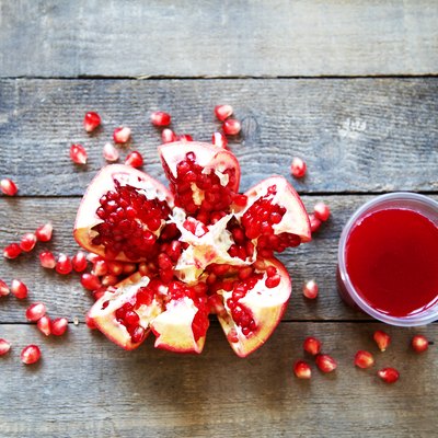 Ripe pomegranate fruit on wooden vintage background