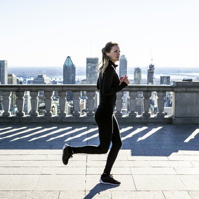 Caucasian woman running in city