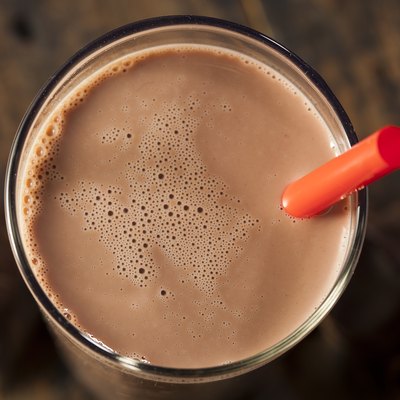 Chocolate milk on a glass with red straw