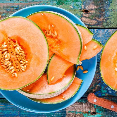 Foods high in potassium like melon on a plate on a rustic background
