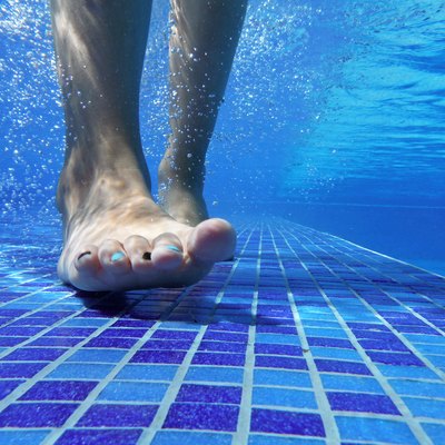 Underwater shot of feet on pool bottom