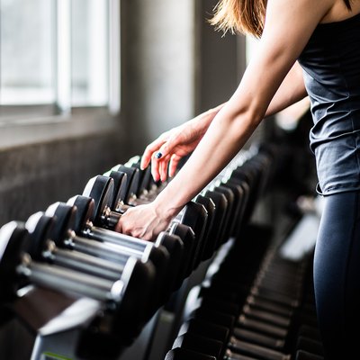 Young Woman Exercising In Gym