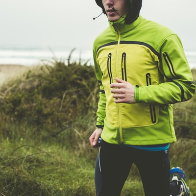 Man running in the rain on the beach
