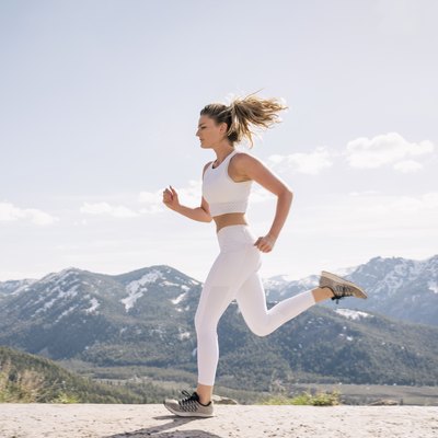 Young woman running in mountain setting