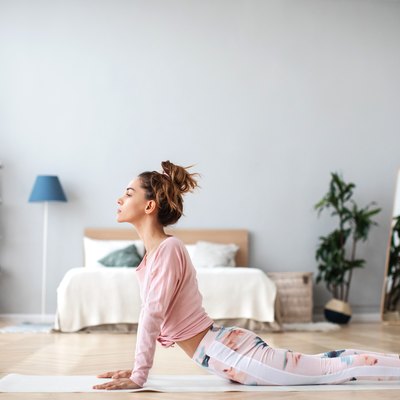 Woman yoga practicing concentration and balance exercises at home.