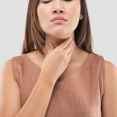 Asian women have symptoms of burning sensation on a gray background