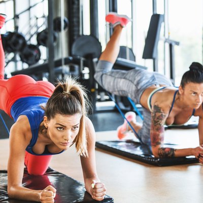 Women doing glute kickbacks to shape and tone their booty