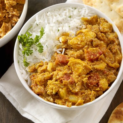 Chicken tikka masala and white rice in a bowl.