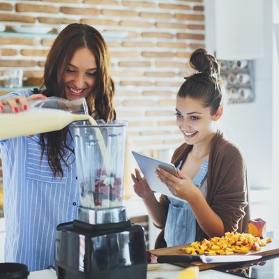 Women making smoothie in kitchen with healthy swaps to eat less sugar