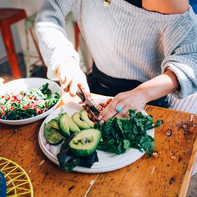 Woman knows how to get more fiber in diet by making salad