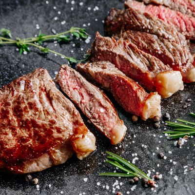 Grilled sliced beef steak with rosemary close up