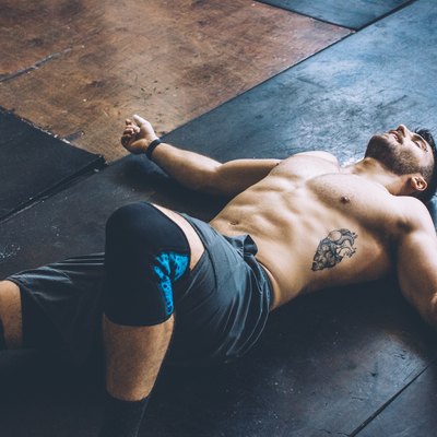 Man lying on the floor after leg day workout