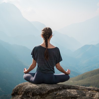Woman meditates in yoga asana Padmasana
