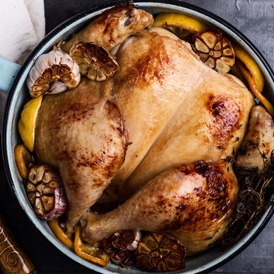 Homemade roasted chicken with spices, thyme and lemon
