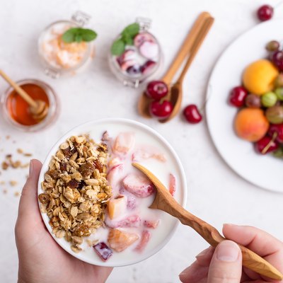 Cropped hands of woman holding bowl of cereals