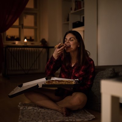 Hungry woman having a slice of pizza