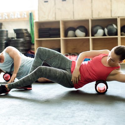 People in gym using support roller