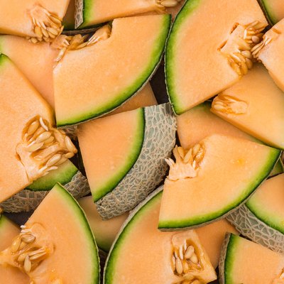 Cantaloupe melon slices, full frame food background