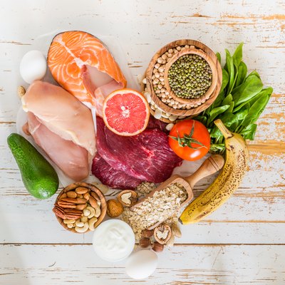 A selection of foods with healthy fats, including salmon, nuts and avocado