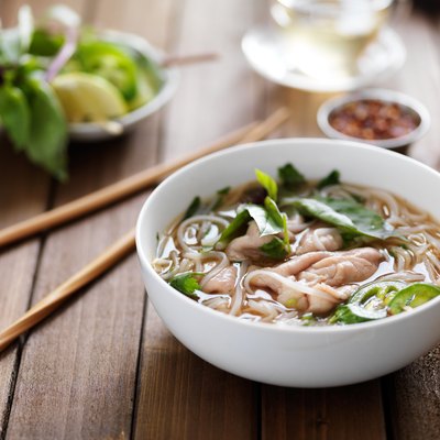 vietnamese beef pho with chopsticks on wooden table