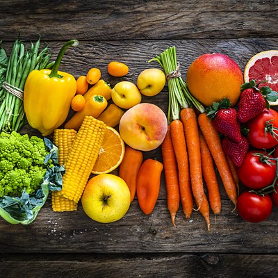 Healthy fresh rainbow colored fruits and vegetables in a row