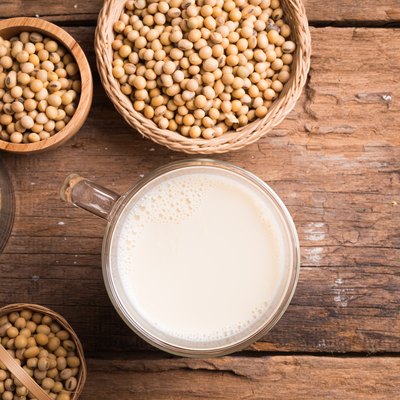 Glass with Soy Milk and Seeds on background